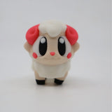 Cute 3D printed sensory sheep toy with big eyes, red horns, and soft pastel colors