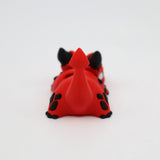 Red and black 3D printed sensory toy animal with tail, viewed from behind on white background