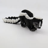 3D printed black and white skunk sensory toy for children on white background