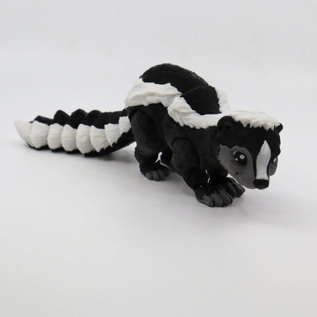3D printed black and white skunk sensory toy for children on white background