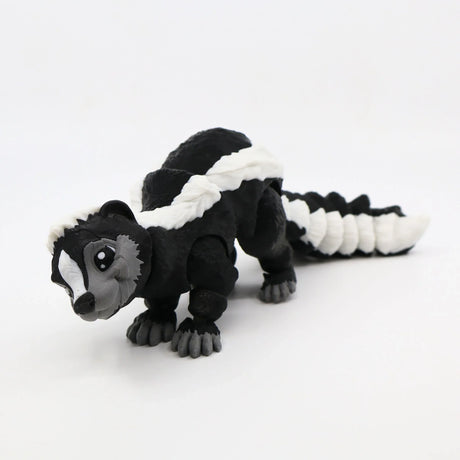 Black and white 3D printed skunk sensory toy with articulated segments on white background