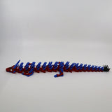 Red and blue 3D printed flexi dragon toy with articulated segments for sensory play
