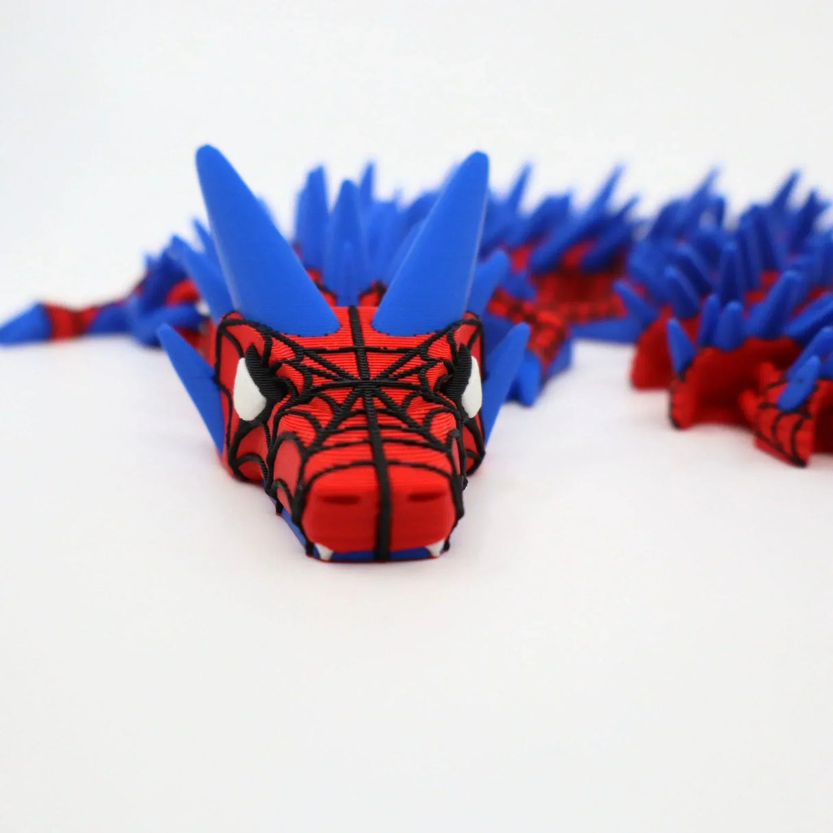 Red and blue 3D printed Spider-Man dragon fidget toy with sensory spikes for kids