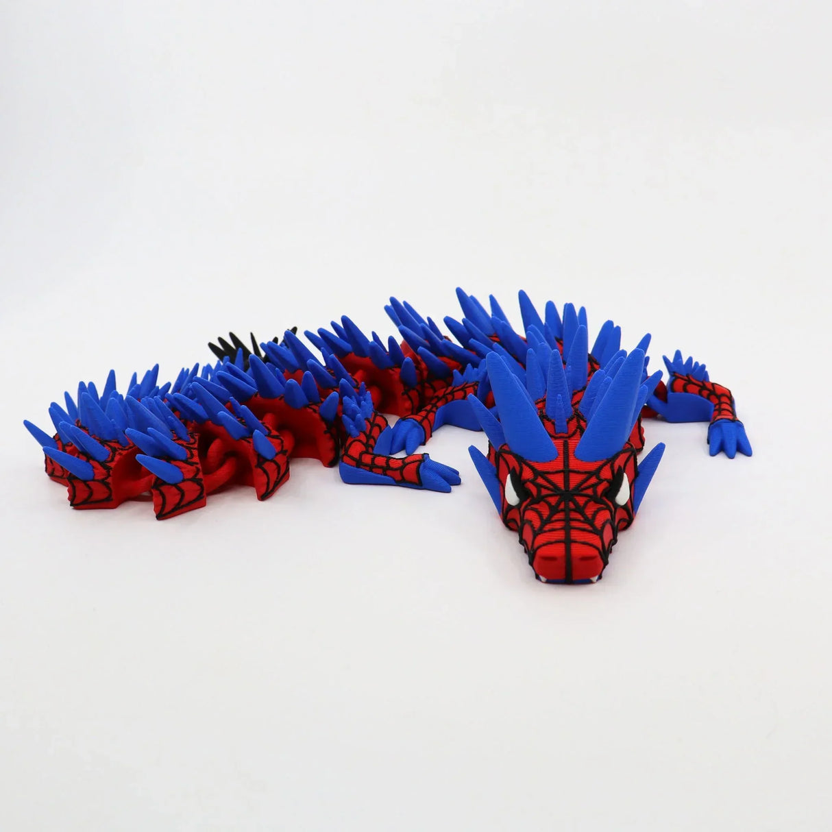 Red and blue 3D printed dragon fidget toy with spikes, designed for sensory play and tactile stimulation.