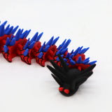 Red and blue 3D printed spiky caterpillar fidget toy with black head for sensory play