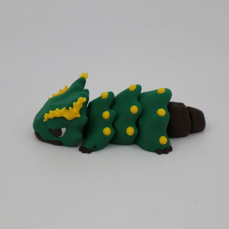 Green and yellow caterpillar-shaped sensory toy with brown accents on a white background