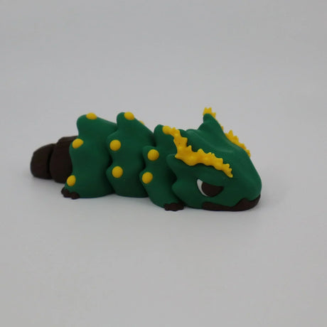 Colorful 3D printed green caterpillar sensory toy with yellow spikes on white background