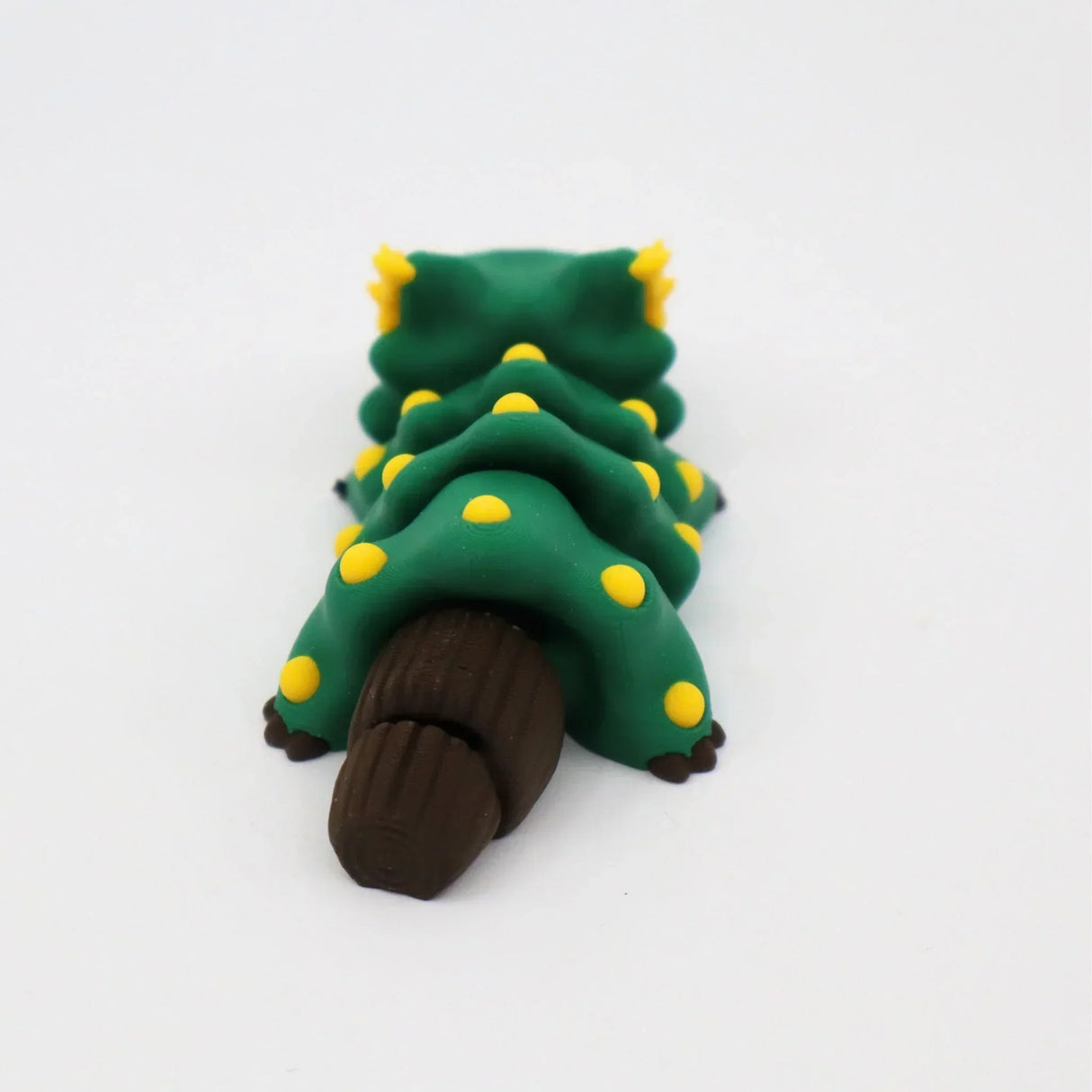 Green 3D printed caterpillar sensory toy with yellow spots and brown segmented tail on white background.