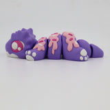 Purple 3D printed sensory toy animal with pink sprinkle details and articulated segments