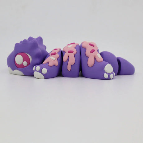 Purple 3D printed sensory toy animal with pink sprinkle details and articulated segments