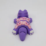 Purple dinosaur sensory toy with pink frosted sprinkles, 3D printed fidget figure