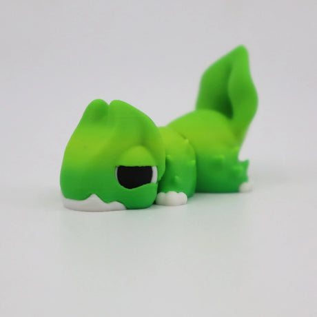 Green 3D printed sensory toy dinosaur lying down on a white background