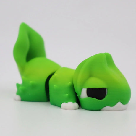 Green 3D printed sensory toy lizard with white accents, designed for tactile play