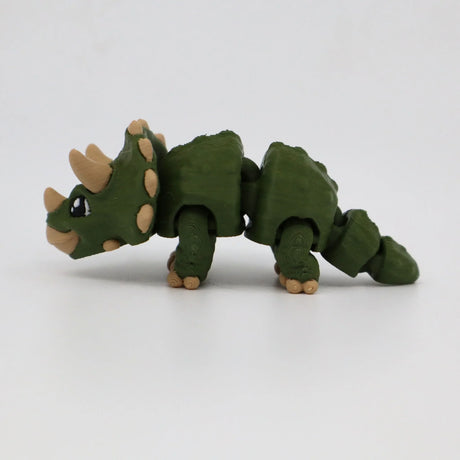 Green 3D printed triceratops sensory toy with flexible joints on white background