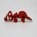 Red and white 3D printed triceratops sensory toy with articulated limbs on white background