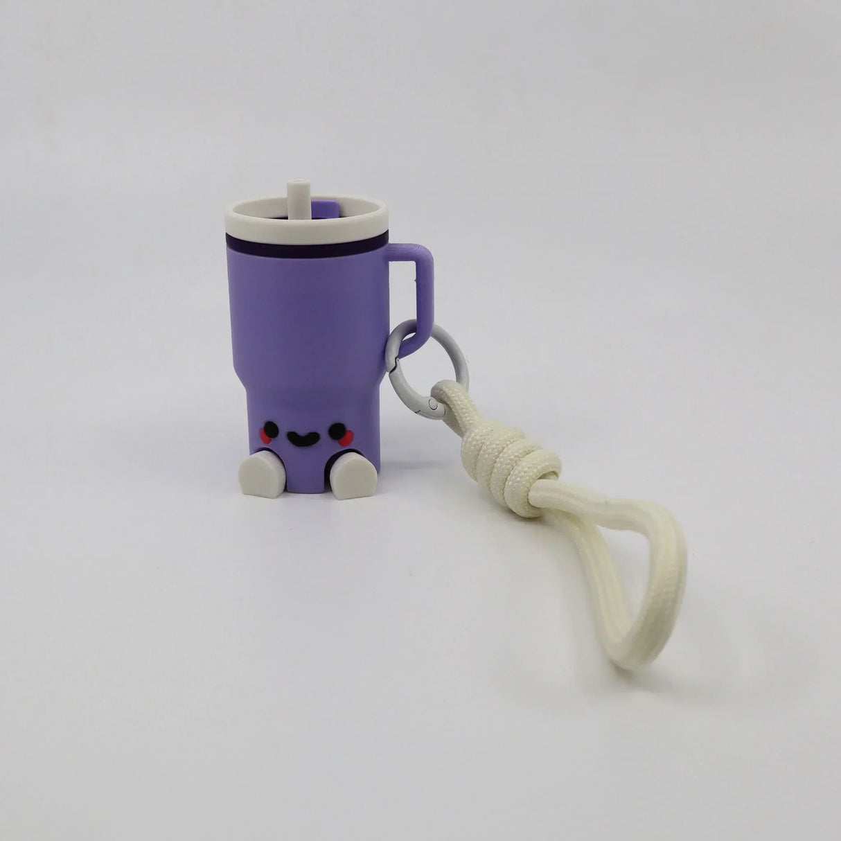 Purple 3D printed fidget toy shaped like a cute mug with handle, smiley face, and keychain strap for sensory play