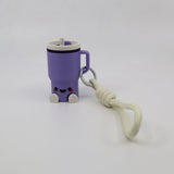 Purple 3D printed fidget toy shaped like a cute mug with handle, smiley face, and keychain strap for sensory play