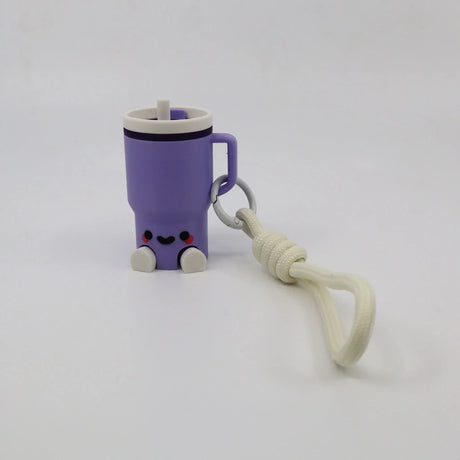 Purple 3D printed fidget toy shaped like a cute mug with handle, smiley face, and keychain strap for sensory play