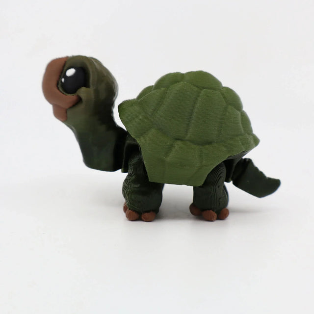 3D printed green turtle sensory toy with detailed shell and movable limbs on white background