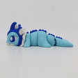 Blue and white 3D printed sensory dragon fidget toy with segmented body on white background
