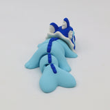 Blue 3D printed sensory toy resembling a segmented dragon or sea creature on white background