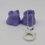 Pair of purple 3D printed animal fidget toys with a white sensory keychain on white background