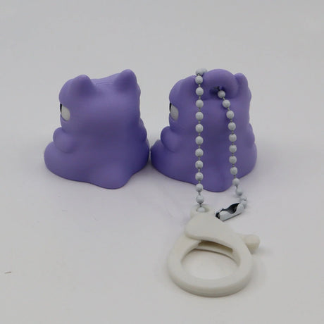 Pair of purple 3D printed animal fidget toys with a white sensory keychain on white background