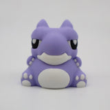 Cute purple 3D printed warthog sensory toy with white details on a plain background