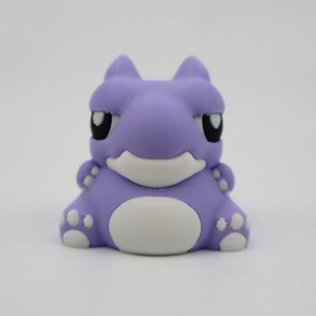 Cute purple 3D printed warthog sensory toy with white details on a plain background