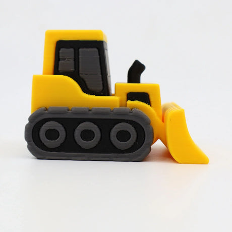Yellow 3D printed sensory toy bulldozer with black tracks on white background