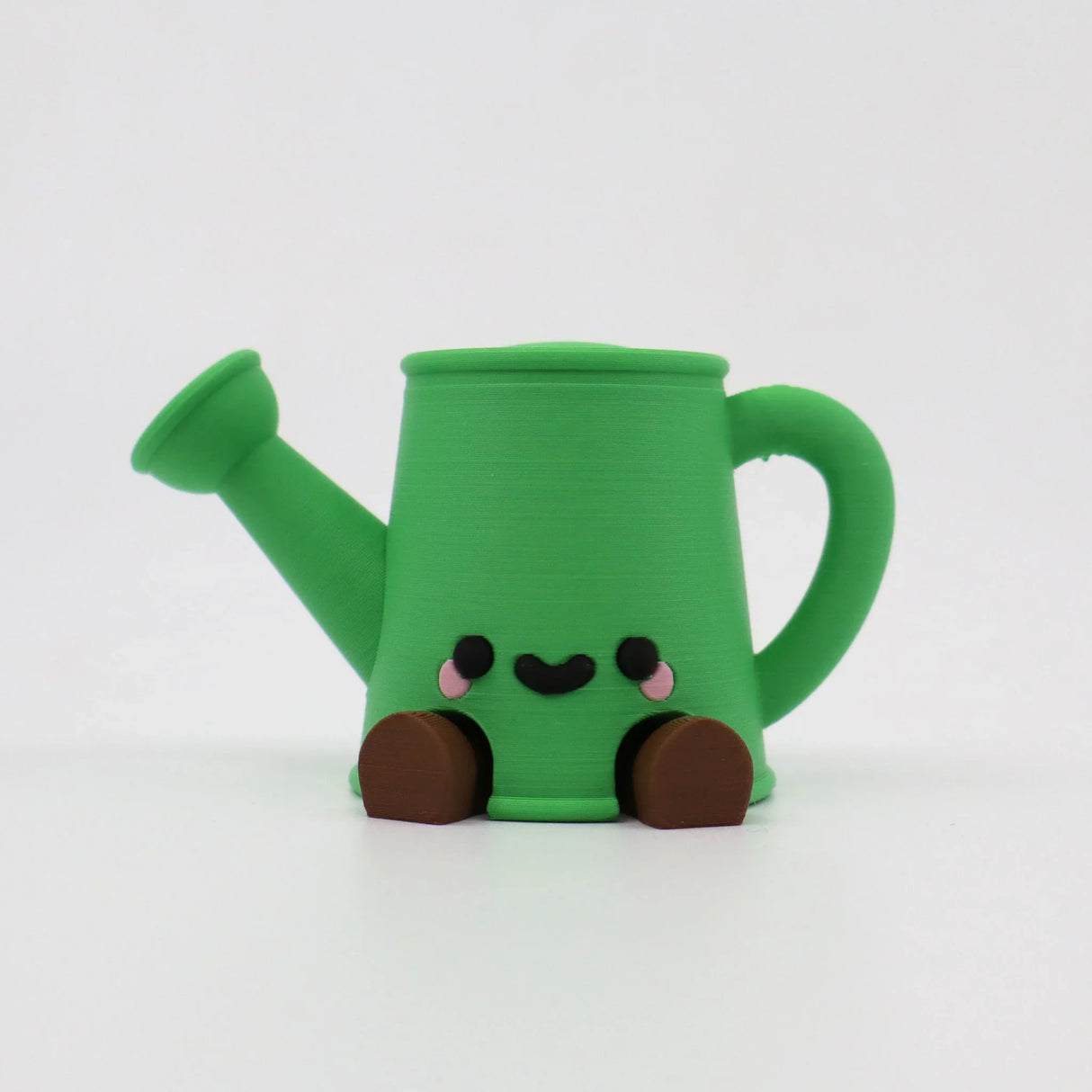 Green 3D printed watering can fidget toy with cute face and brown feet for sensory play