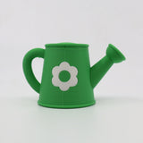 Green 3D printed sensory toy watering can with white flower, ideal for tactile play and learning
