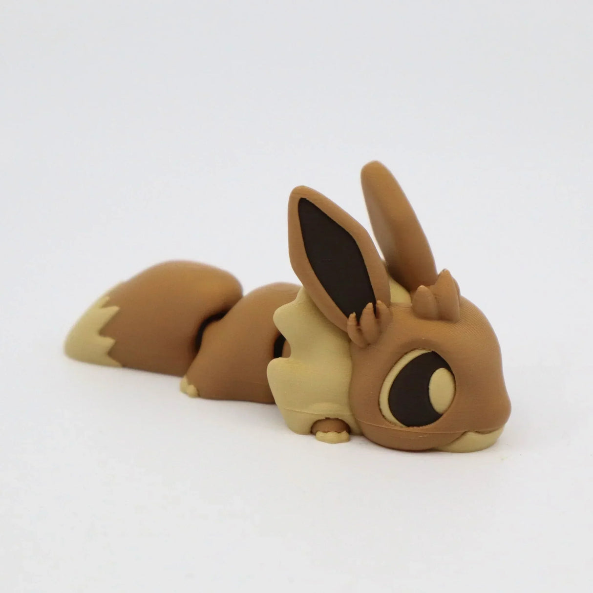 3D printed brown flexible animal sensory toy with large ears on white background
