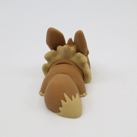 3D printed brown sensory toy shaped like a dog laying down, shown from behind