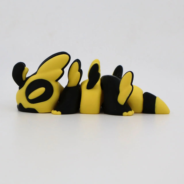 Yellow and black 3D printed sensory toy shaped like a segmented bee on a white background