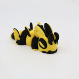 Yellow and black 3D printed sensory animal toy with insect features on white background