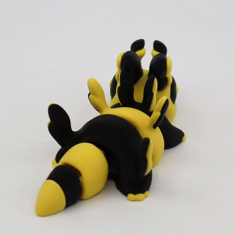 Yellow and black 3D printed segmented sensory toy animal on white background